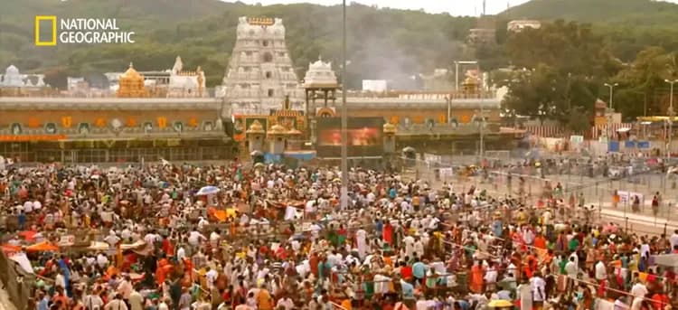 Devotees gathered at a temple courtyard with a towering gopuram — Darshan Puja purpose of devotion